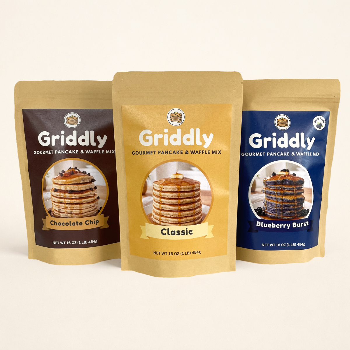 Three packages of Griddly gourmet pancake and waffle mix on a white background